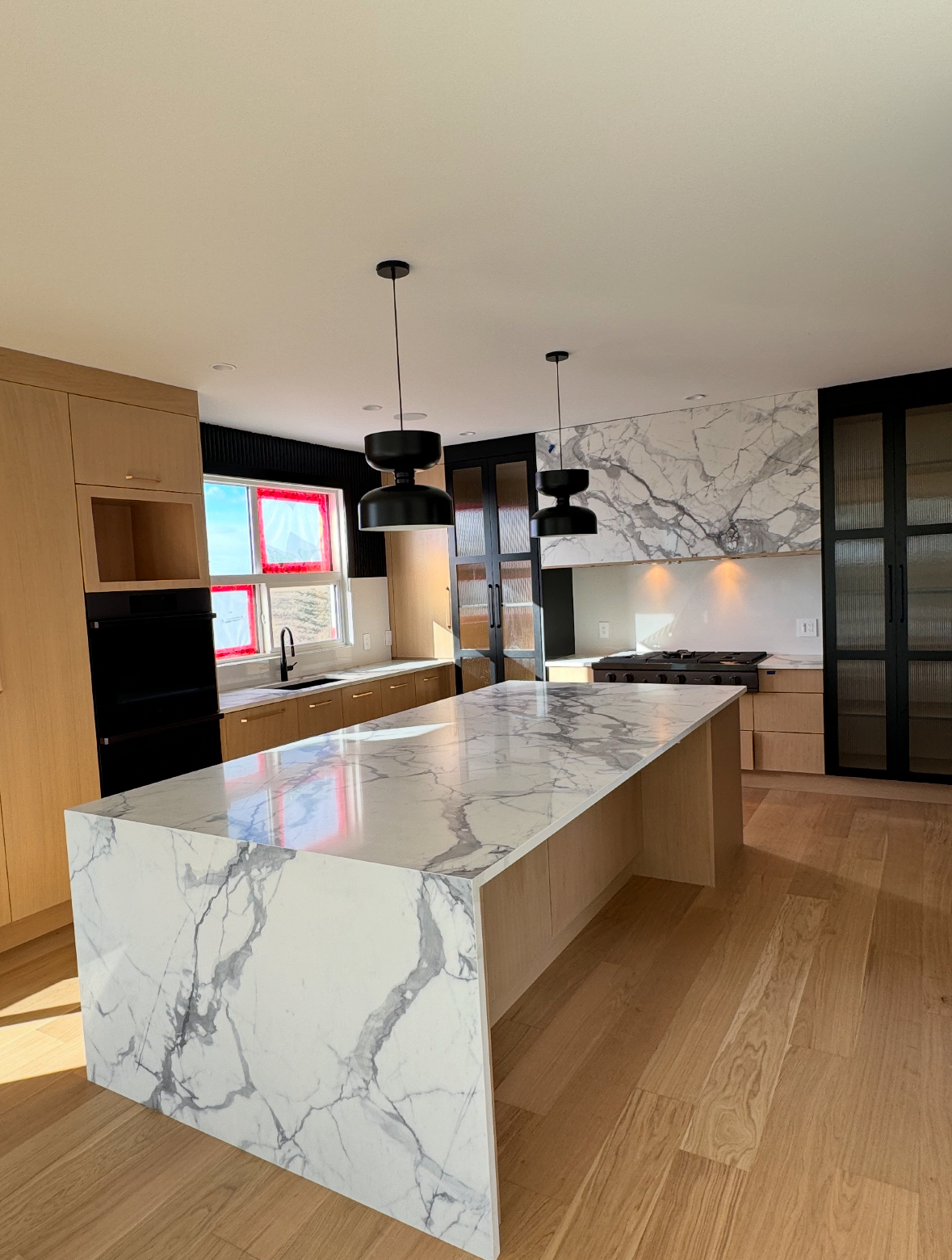 Modern Calgary kitchen renovation with marble waterfall island